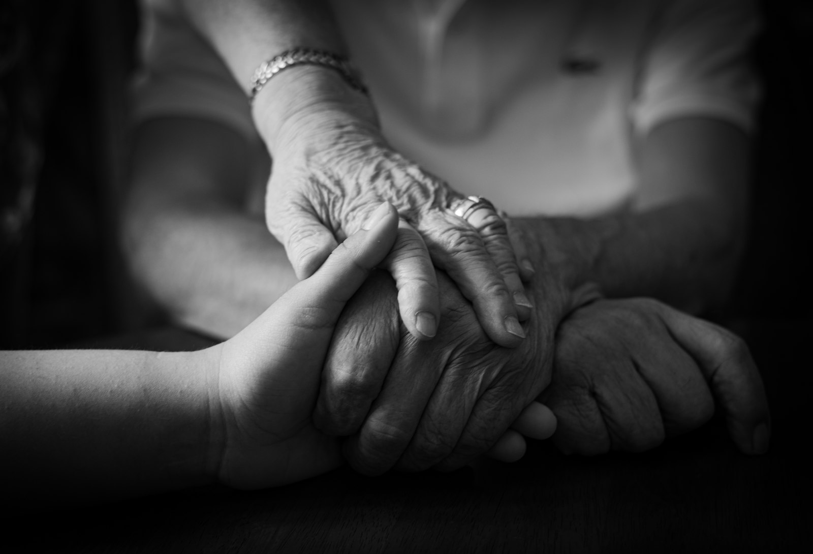 Two hands gently held in comfort and care